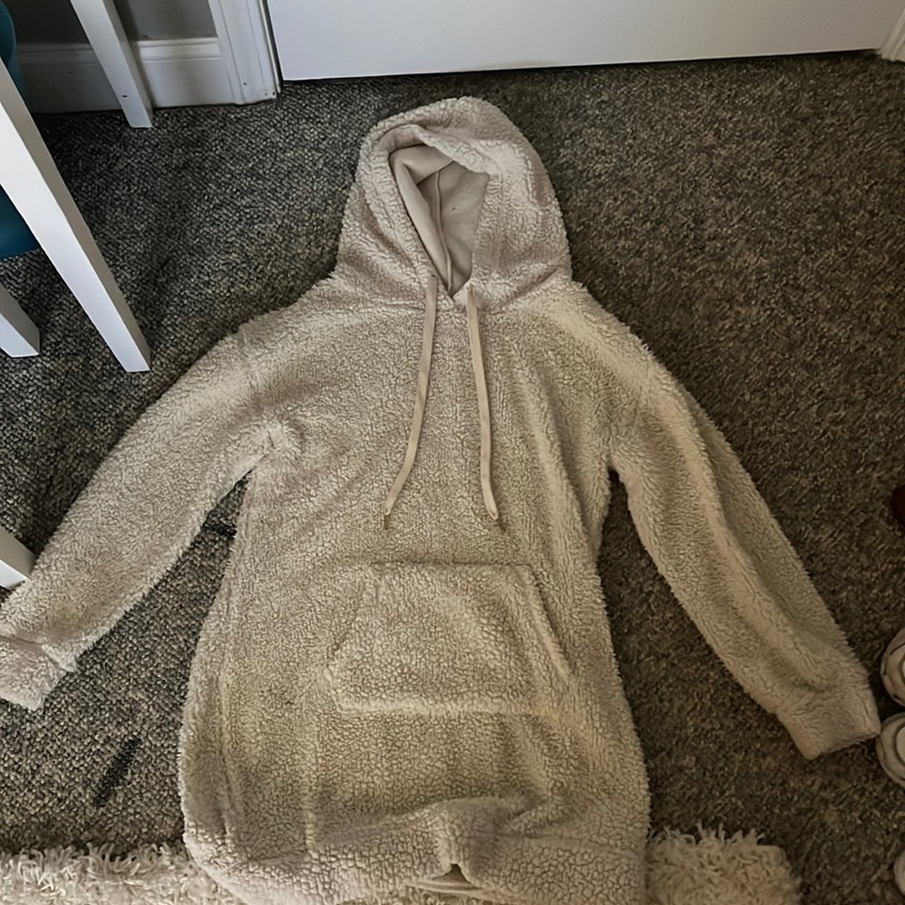 This is a sized large comfy and fuzzy cream-colored hooded sweatshirt.